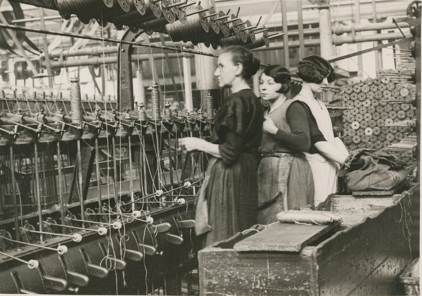 Winding machine with two young, and one old, female attendants image