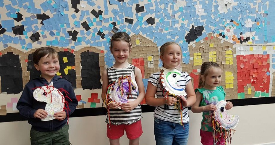 children showing their crafts from event