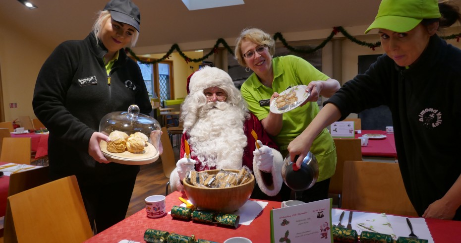 santa surrounded by staff at almond valley