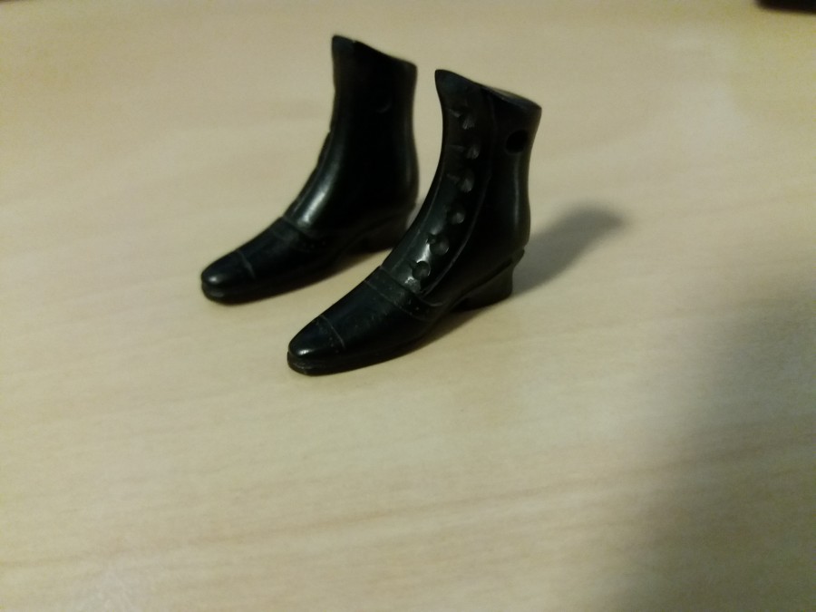 pair of boots carved out of coal