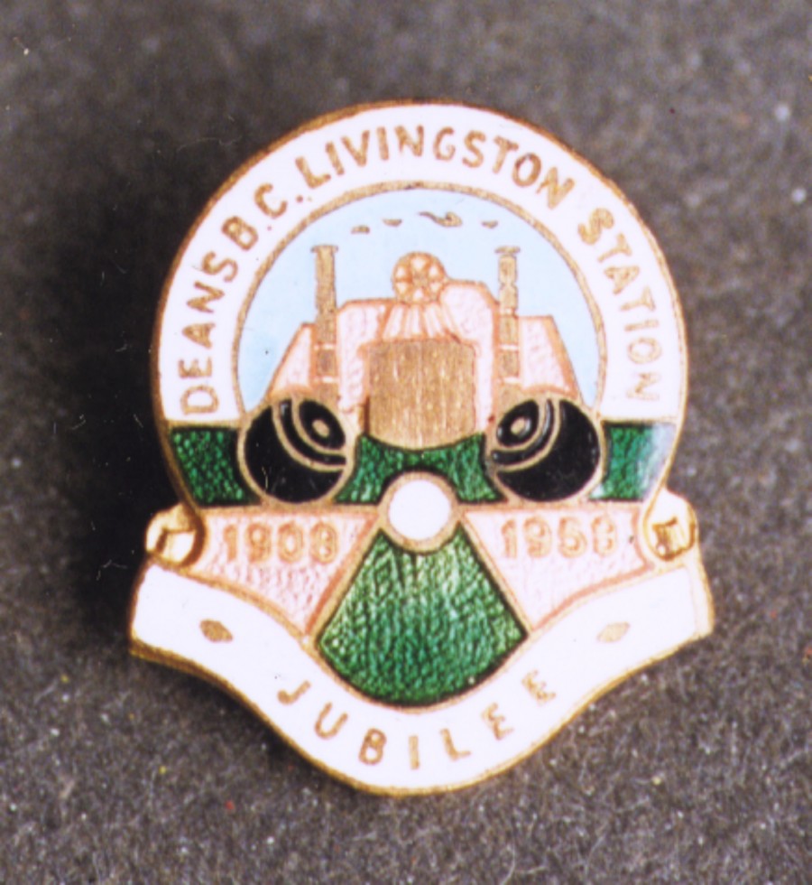 badge commemorating 50th jubilee of deans B.C. livingston station. depicted is mine in background and two bowling balls in foreground