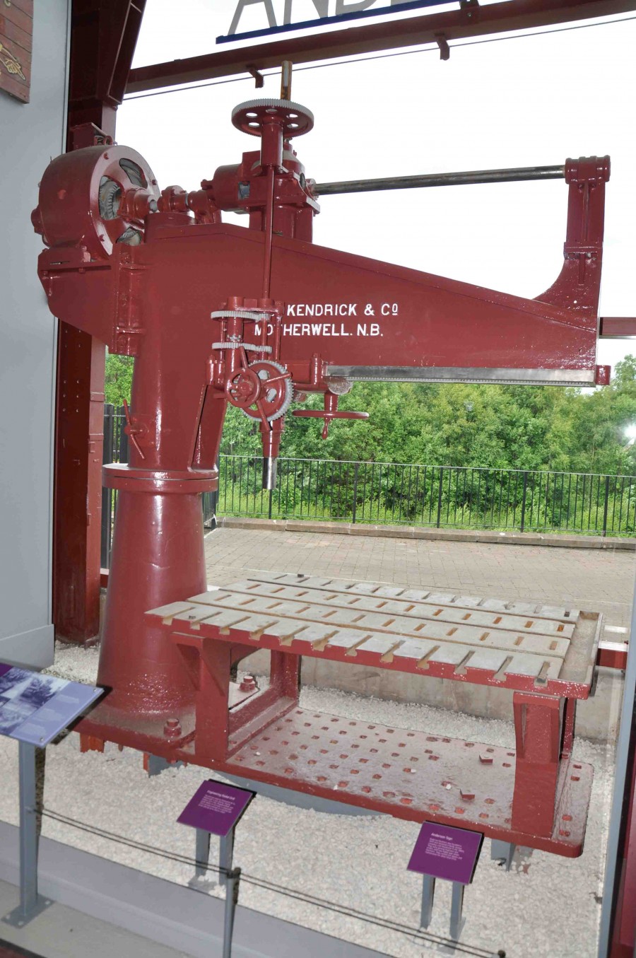 radial drill. painted red, with writing: kendrick & co / motherwell n.b.