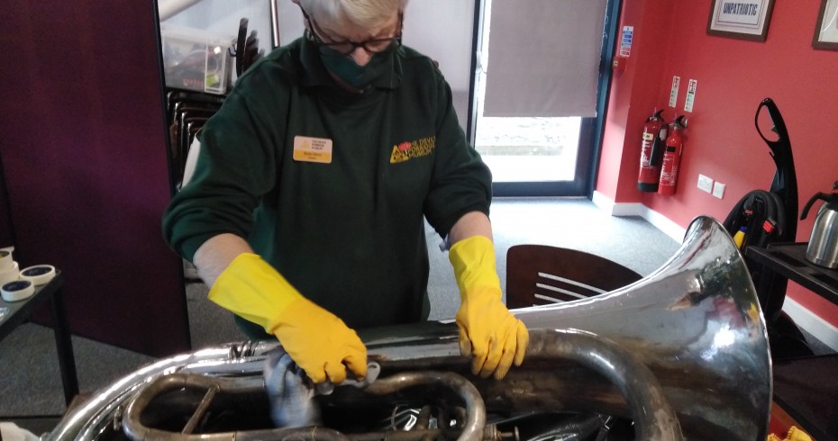 museum workforce cleaning tuba at devil's porridge museum 930