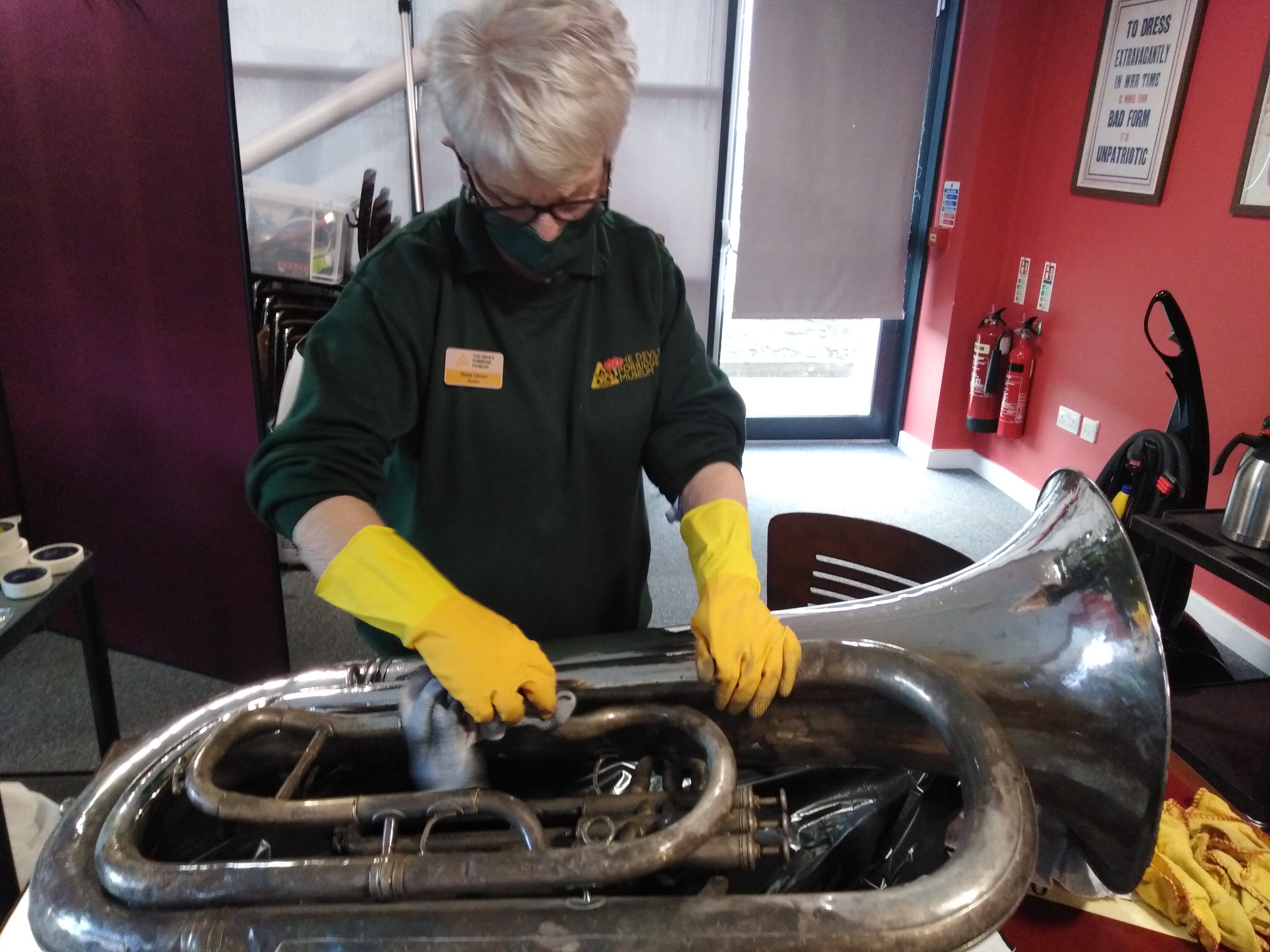 museum workforce cleaning tuba at devil's porridge museum 930