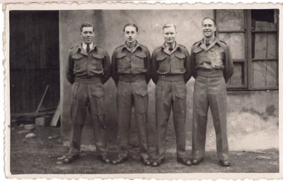 Postcard with four men in uniform image