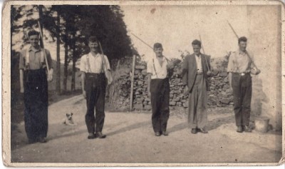 Photograph of five men and a dog image