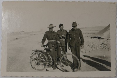 Photograph of three soldiers with bike image